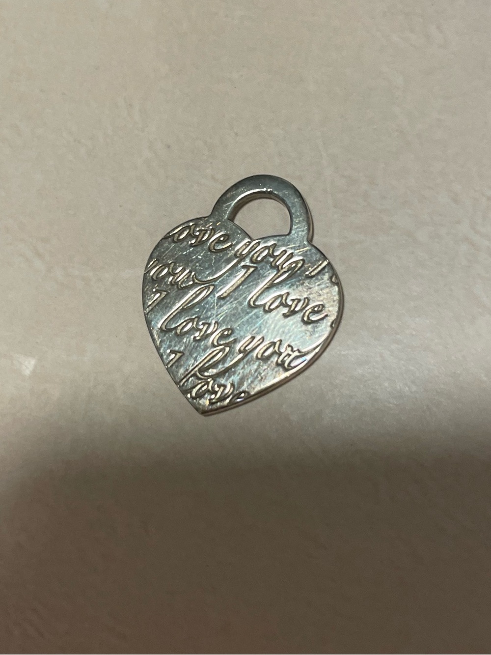 Authentic Tiffany & Co. sterling silver “I Love You” heart pendant charm.